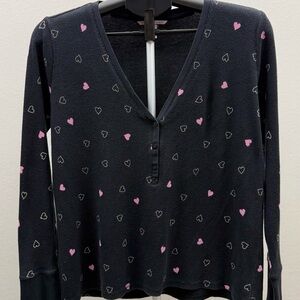 Cozy Victoria’s Secret waffle knit henley top with an allover heart print.